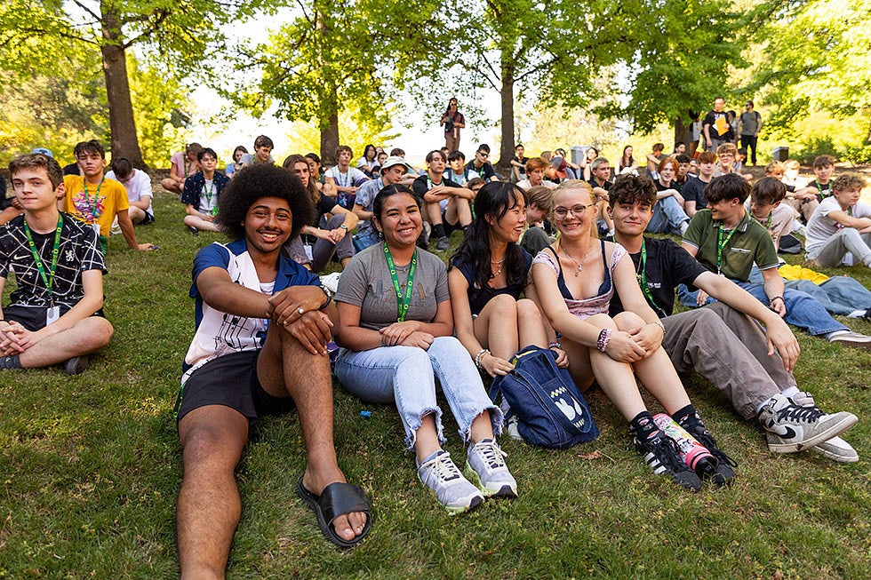 Group of youth sitting outside during a youth program