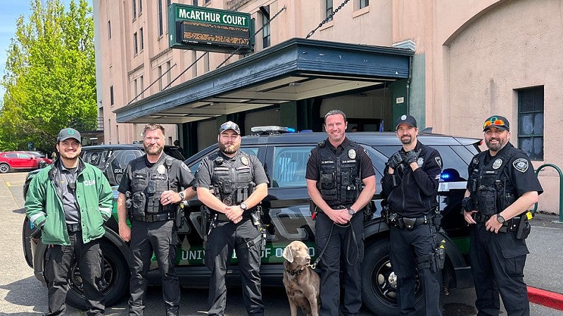 UOPD officers with UOPD dog Thor in front of McArthur Court