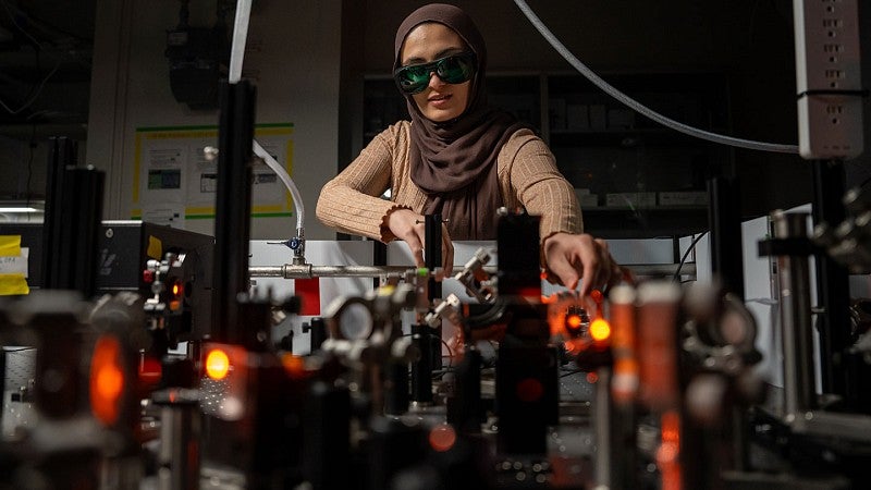 Researcher working in laser lab wearing protective eye glasses