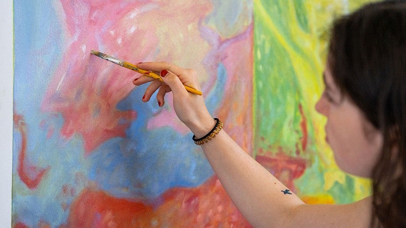 Artist painting in studio
