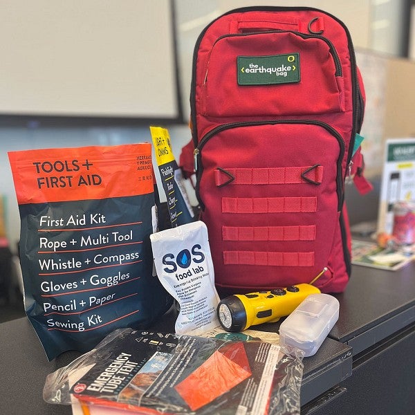 Earthquake bag with tools, first aid kit, emergency tent, emergency water, and flashlight radio