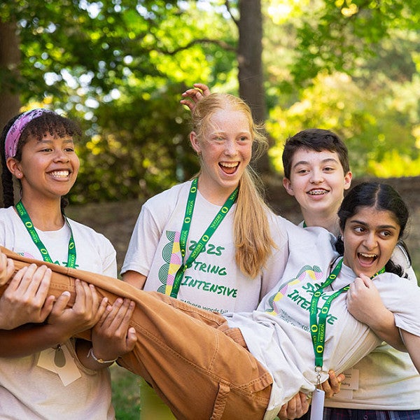 Smiling group of youth wearing string intensive t-shirts, 