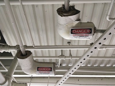Asbestos pipe coverings and labels