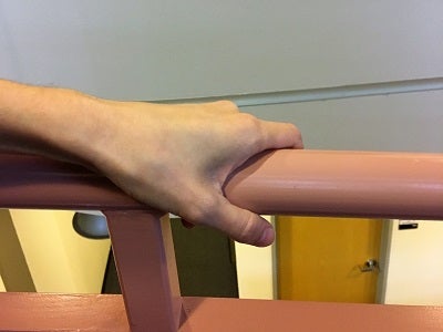 Hand holding handrail
